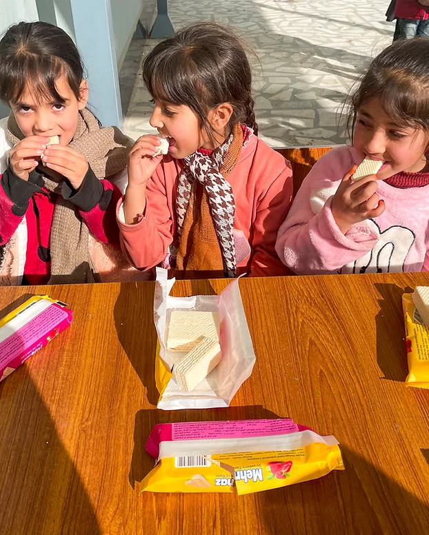 Three girls eating crackers